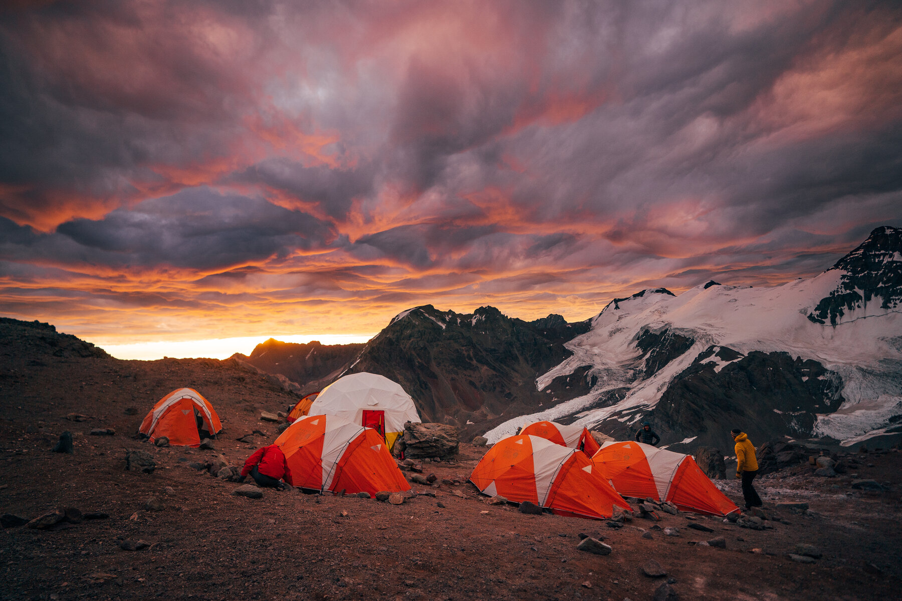 Dramatic sunset over high camp tents on Aconcagua