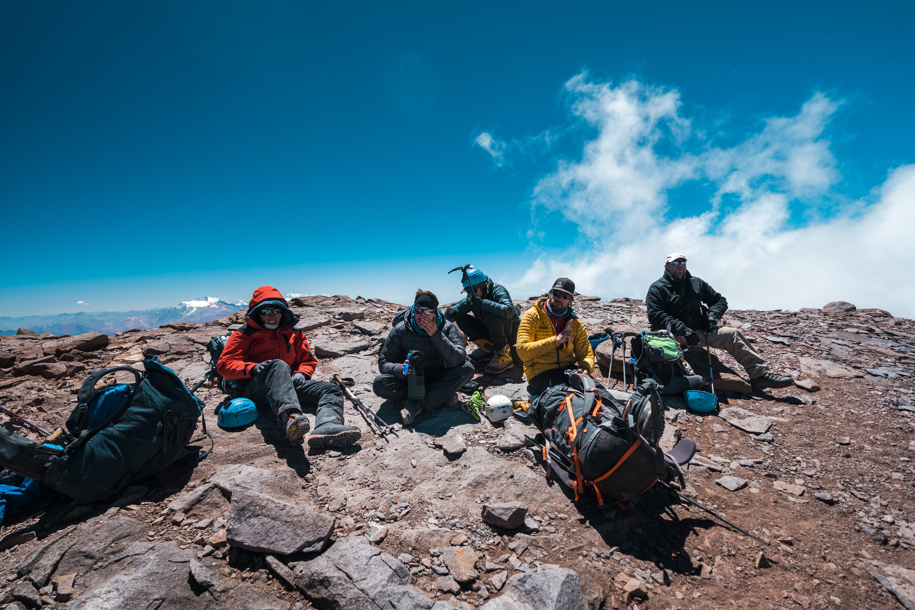 The full climbing team resting together on the summit of Aconcagua