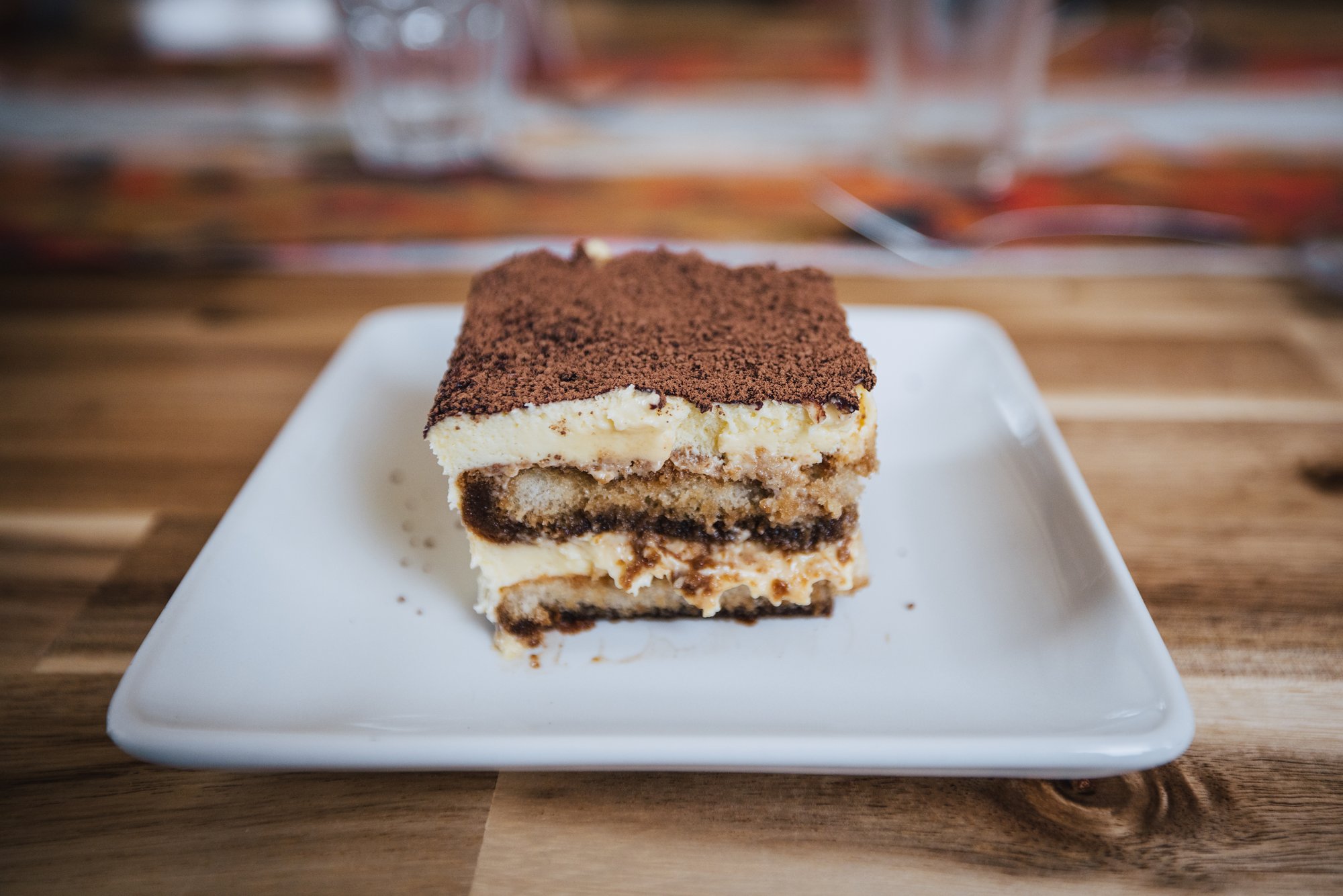 A square of tiramisu dusted with cocoa