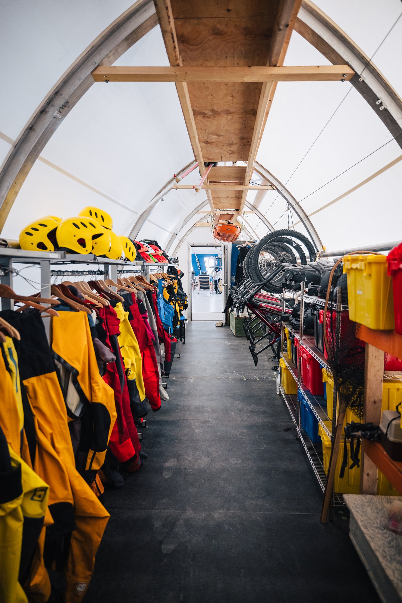 The Arctic Watch gear tent, a long corridor of drysuits, rain gear and helmets