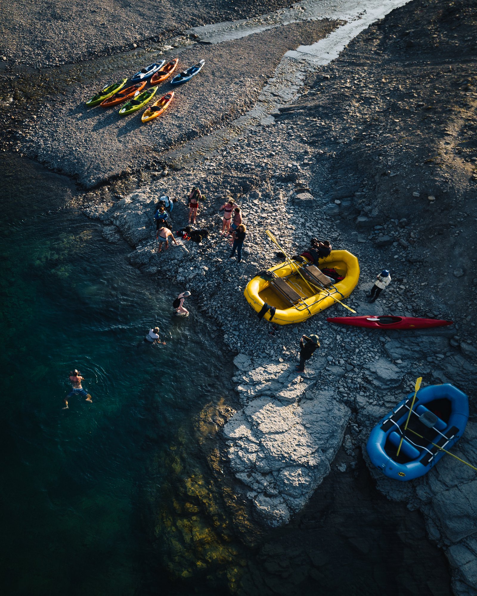 Top-down view of kayaks, rafts and swimmers on the shore after a polar plunge
