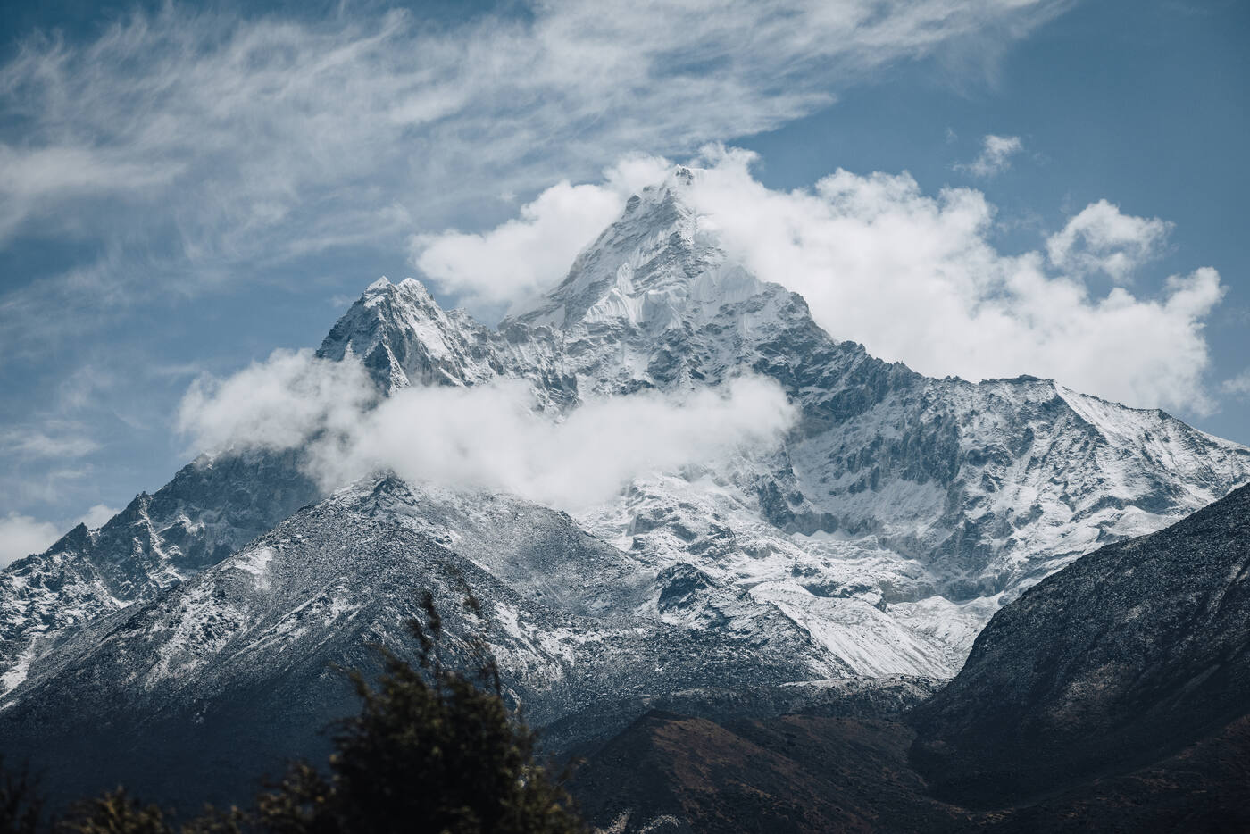 Ama Dablam's distinctive pyramid summit wreathed in cloud — the mountain that defines the Dingboche valley