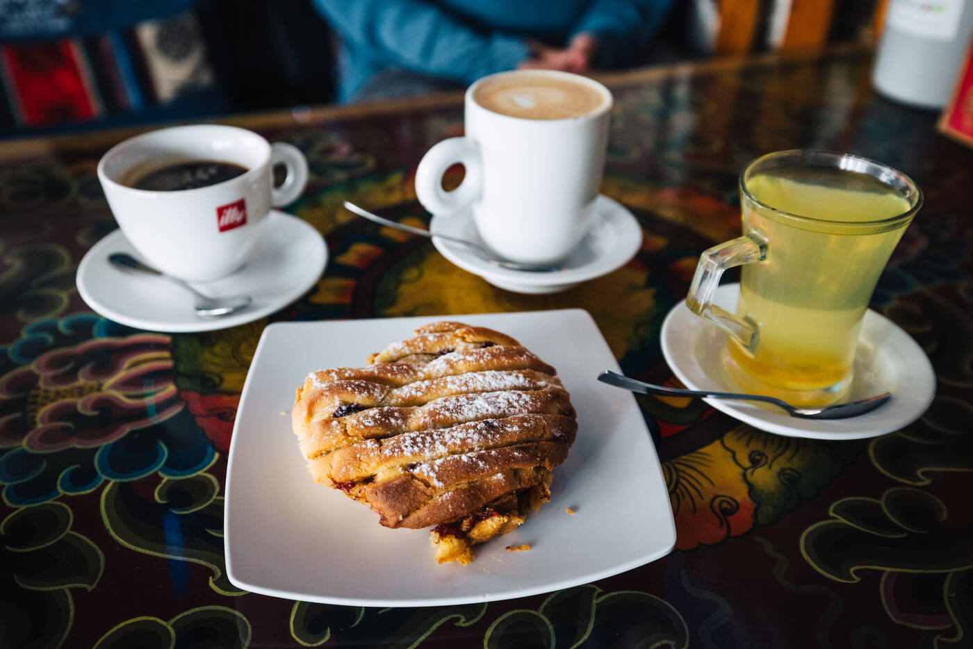 A lattice-top apple pie beside espresso, latte, and lemon tea at Sherpa Barista in Namche