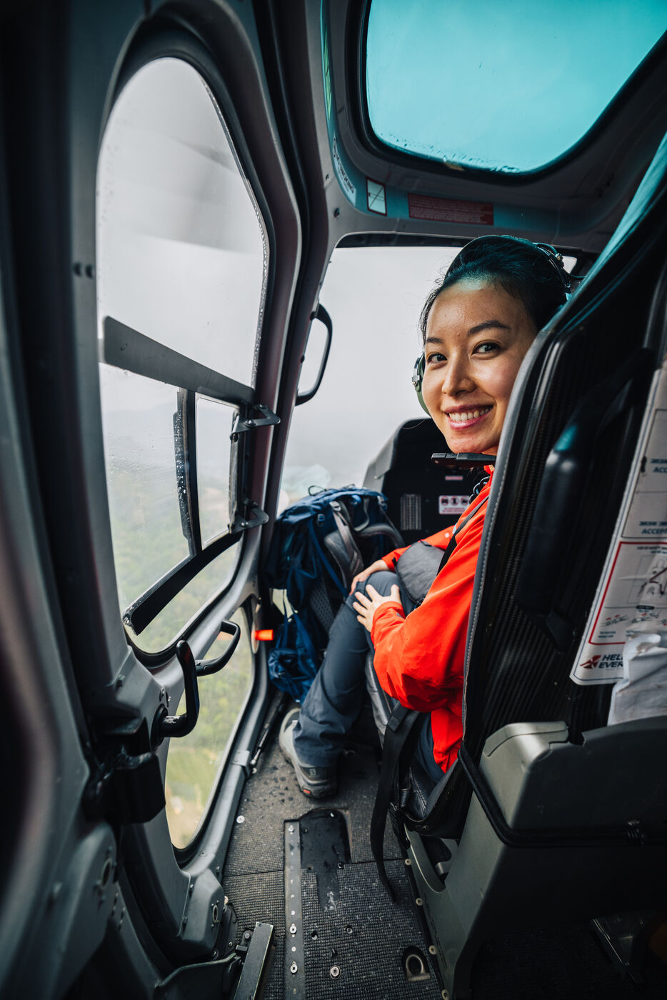 Grace smiling in the helicopter during the flight from Kathmandu to Surke