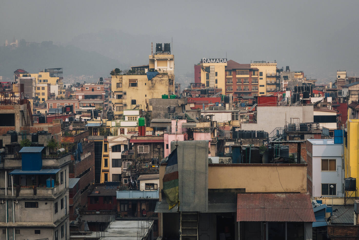 Kathmandu cityscape with densely packed buildings and rooftops stretching into the haze