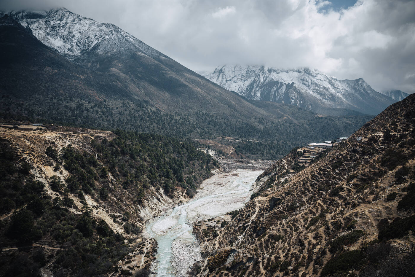 The Dudh Koshi river winding through a deep gorge with snow peaks rising in the distance