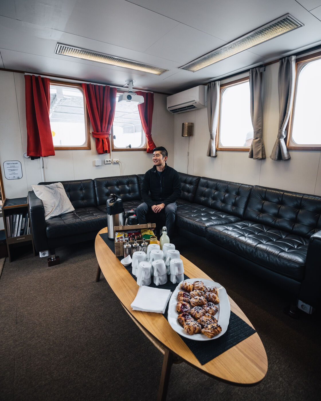 Passenger in lounge area with pastries