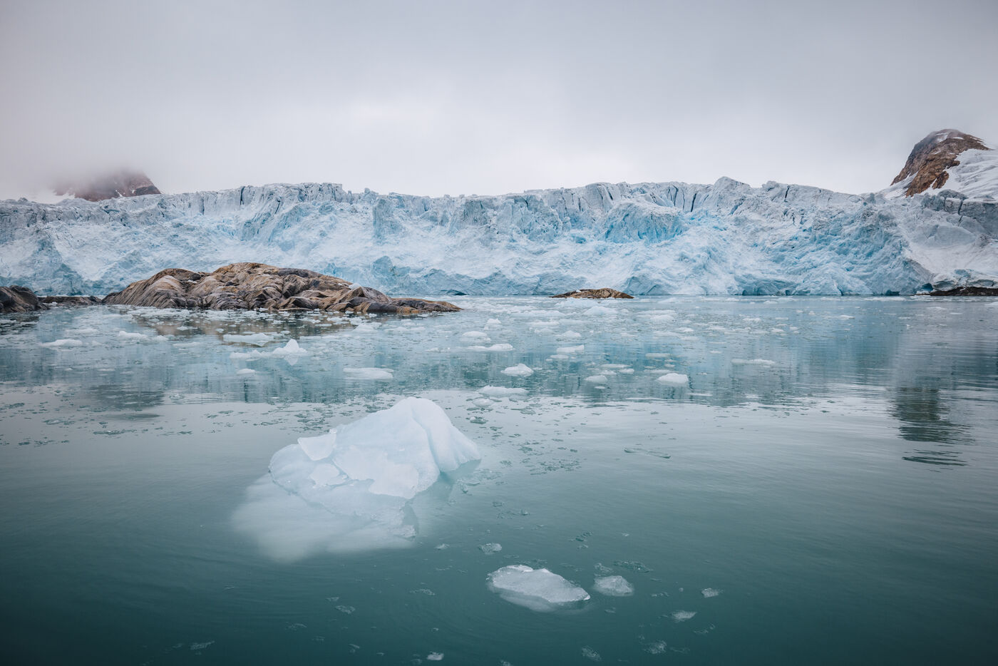Turquoise icebergs floating in fjord