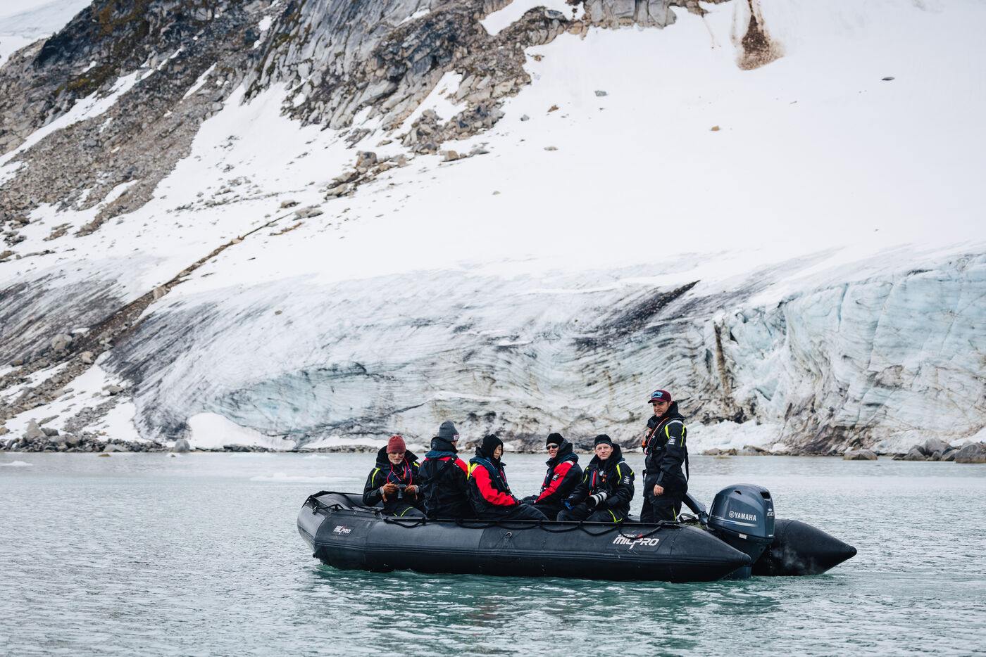 Group in zodiac with mountain backdrop