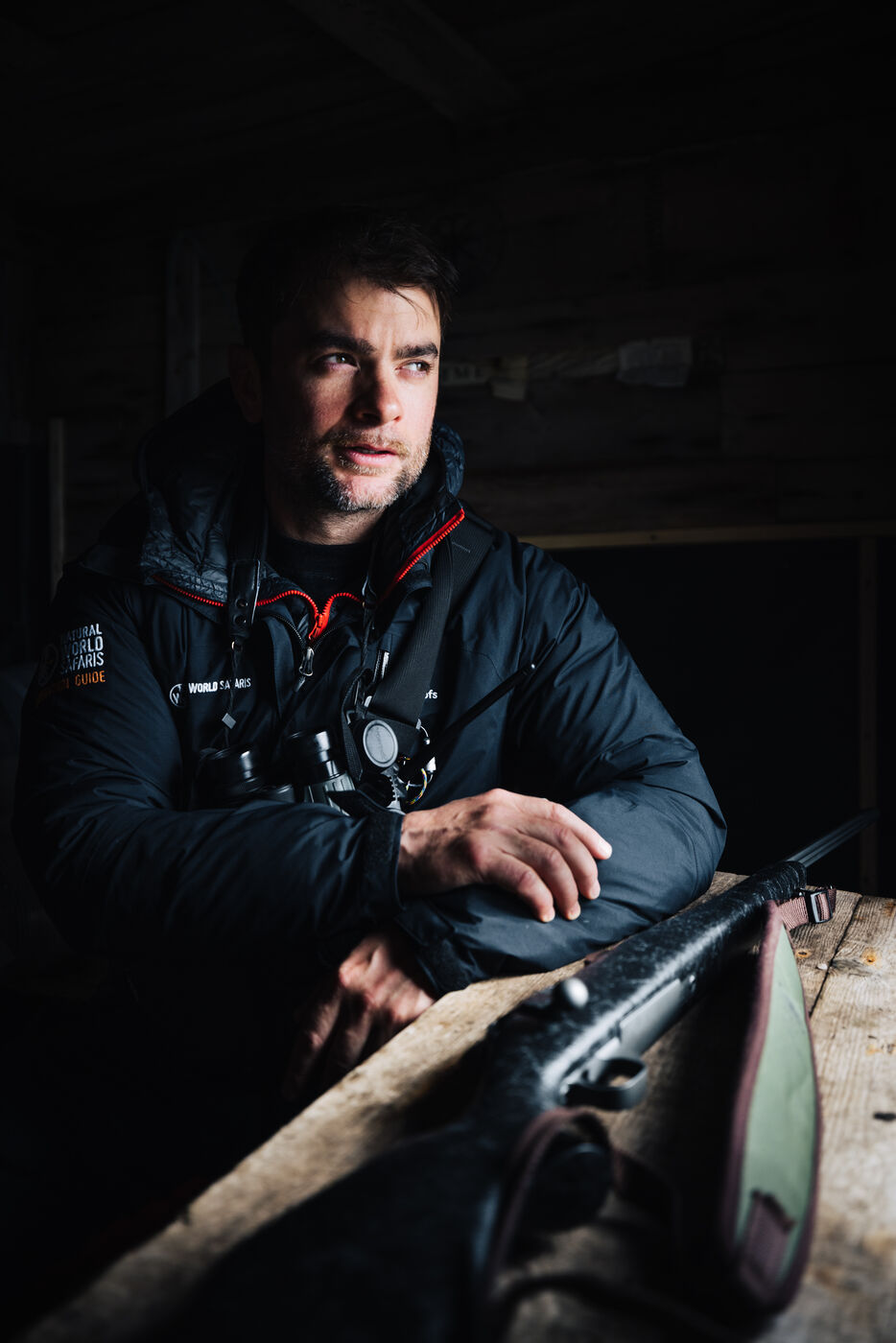 Bearded man sitting inside a wooden structure