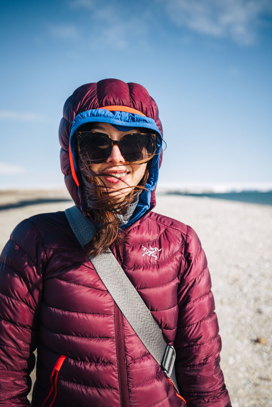 Woman in cold-weather gear on Arctic beach