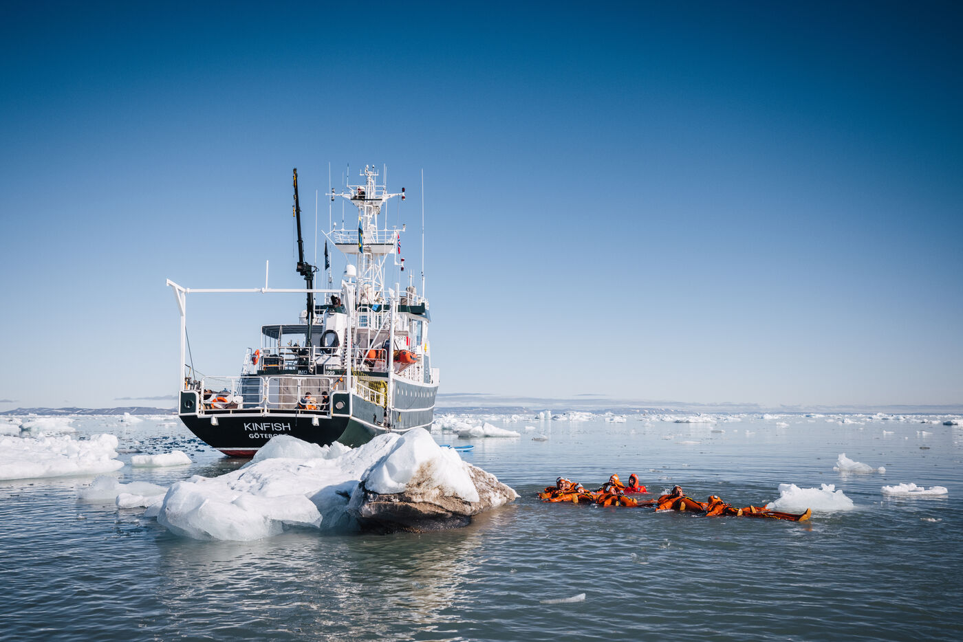 The Kinfish ship with divers in orange suits in water