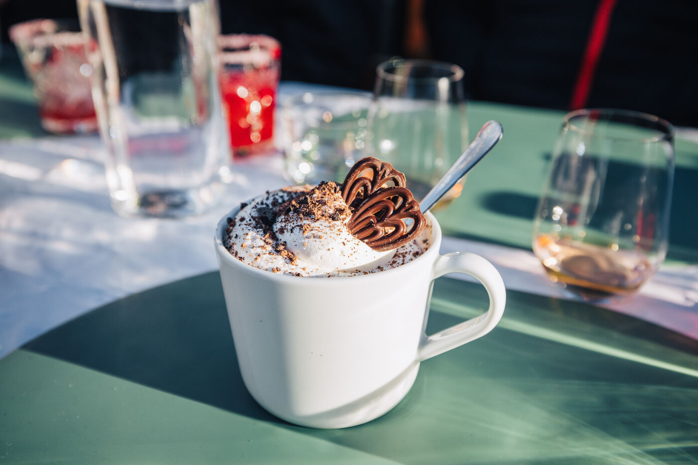 Mug of hot chocolate with cream on ship table