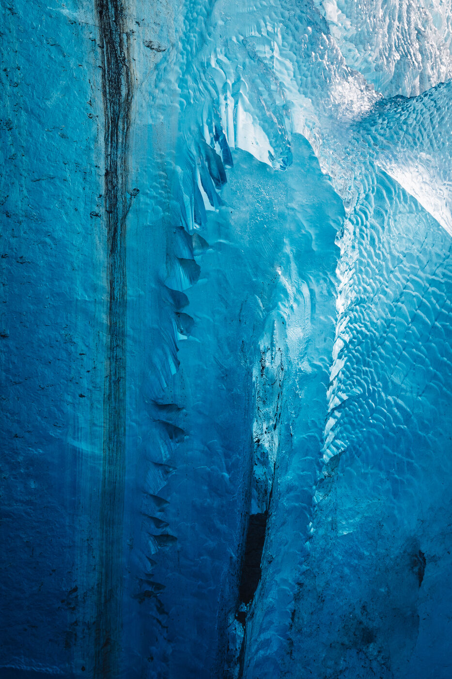 Deep striations in turquoise ice wall