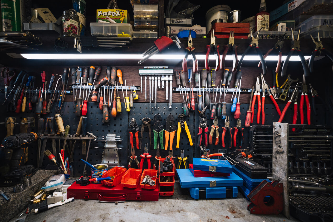 Workshop wall inside the station, pliers and screwdrivers hung in neat rows