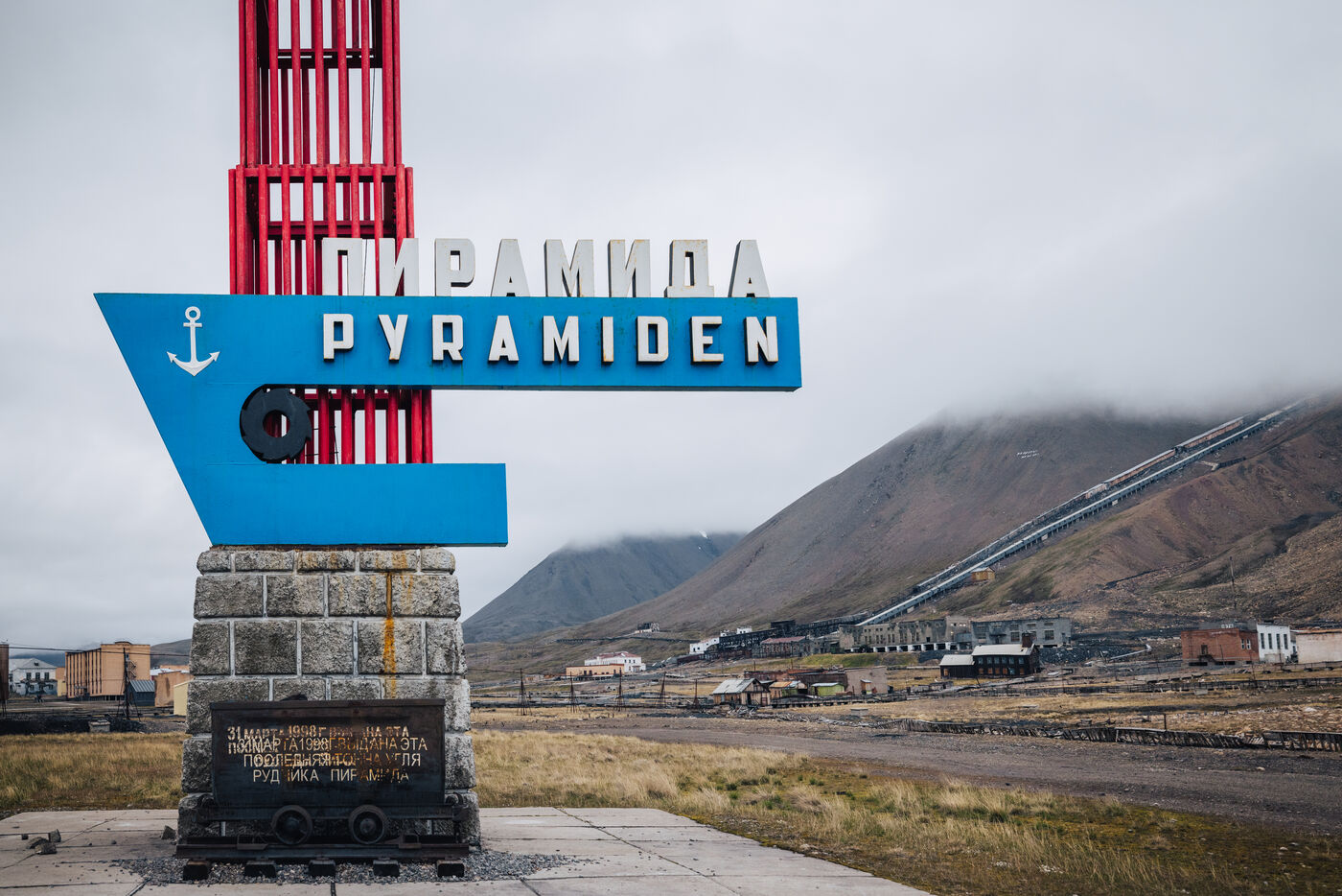 Pyramiden sign with red tower and mountains