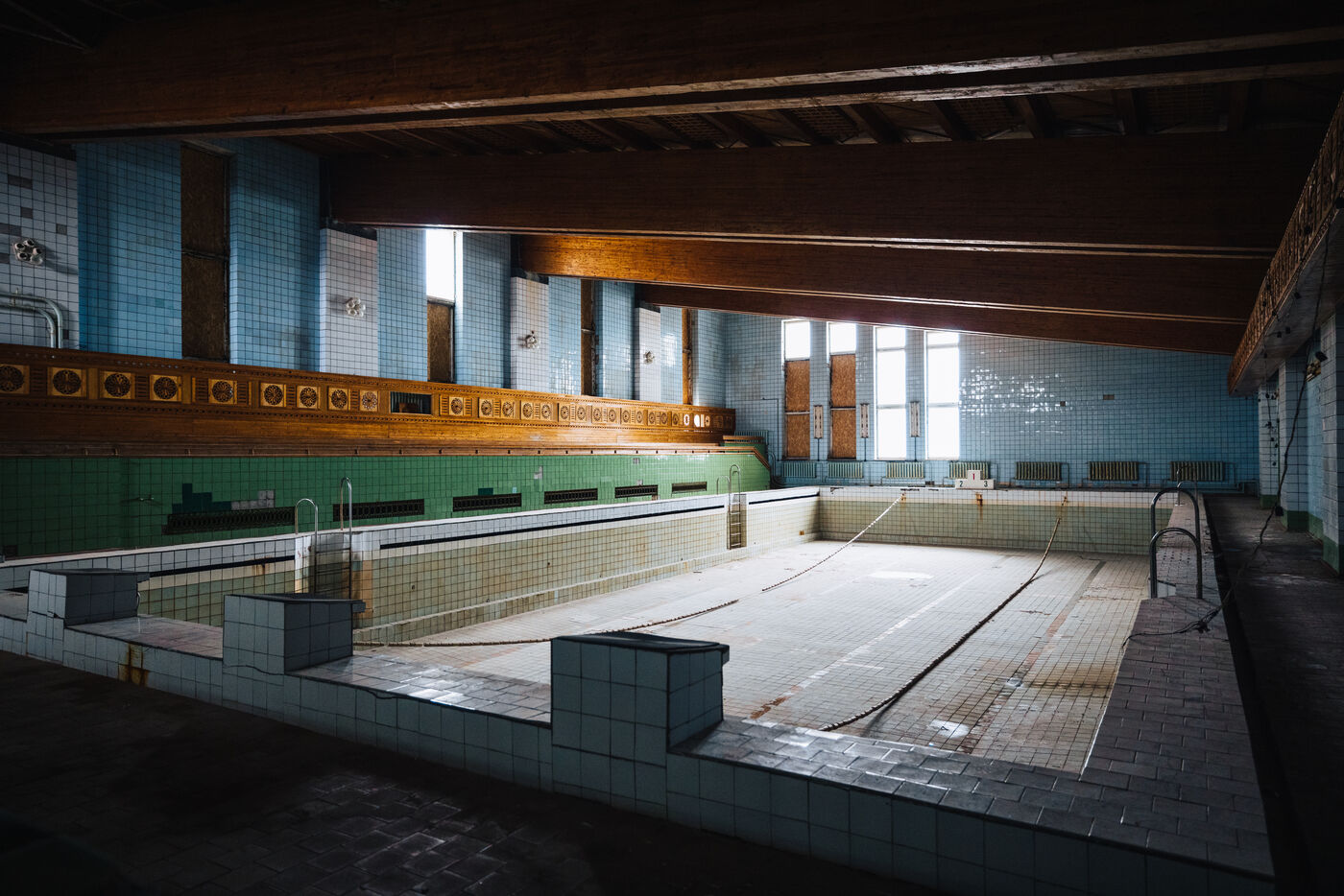 Empty tiled swimming pool inside the sports hall