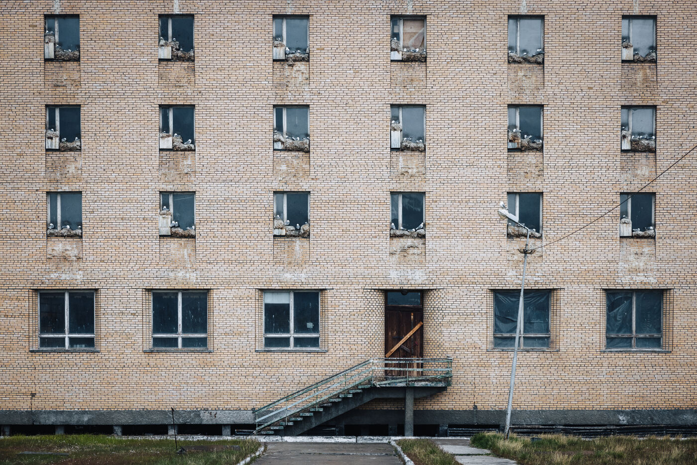 Tan building facade with regular window pattern
