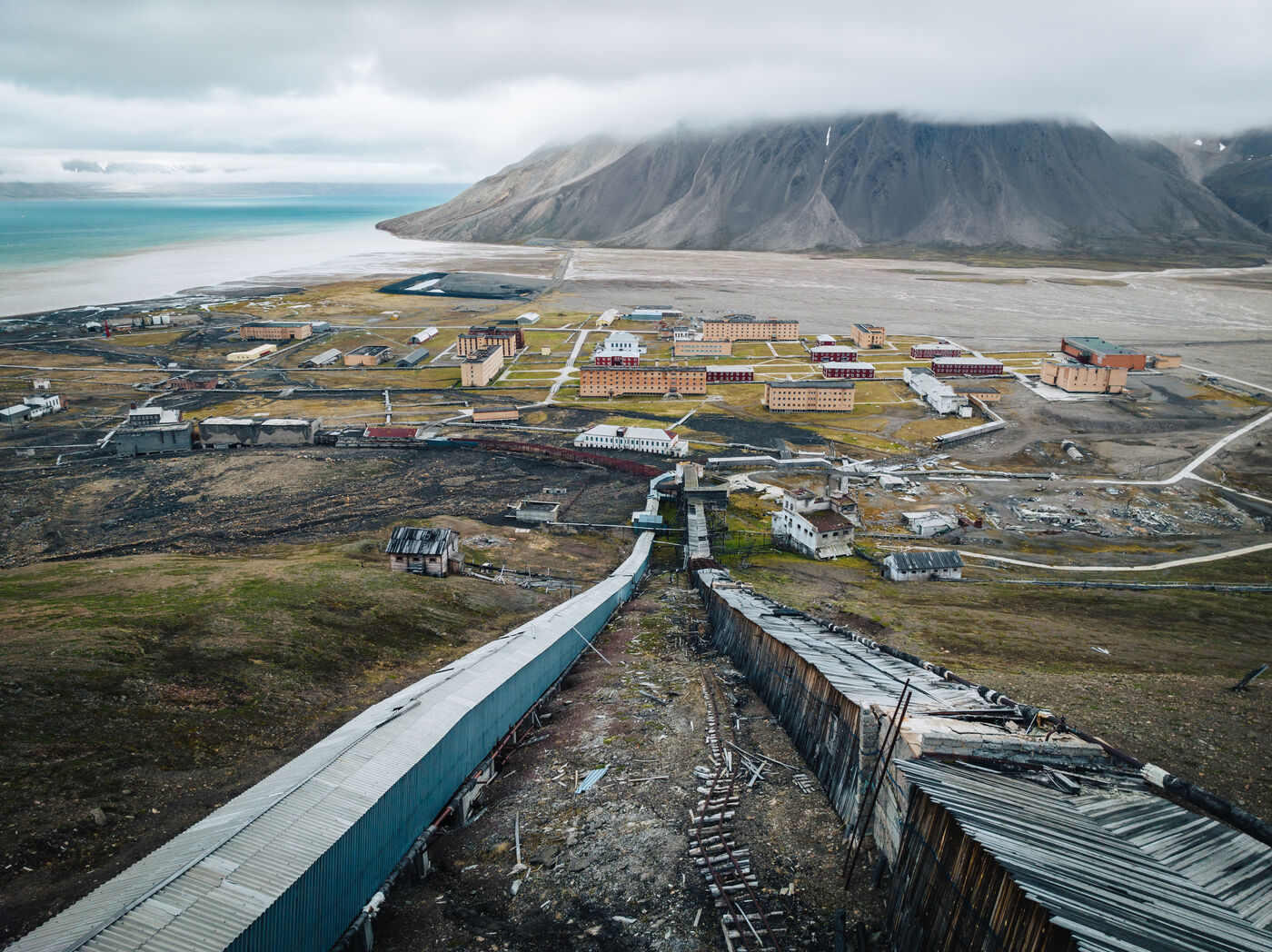 Aerial view of entire settlement with beach and mountains