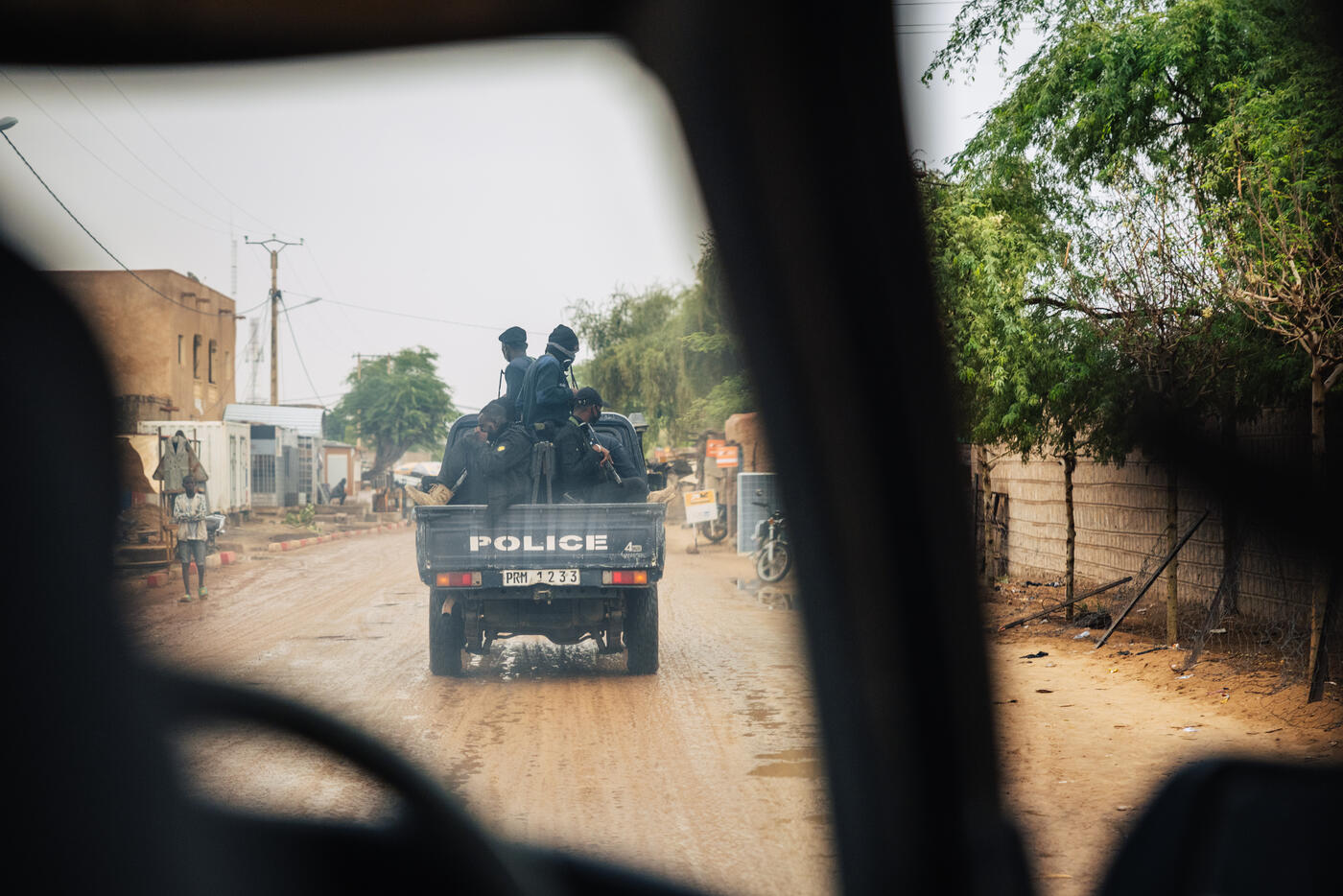 Military escort vehicle on desert road arriving in Timbuktu