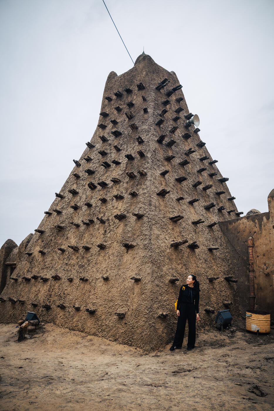 Person at mosque minaret with toron beams
