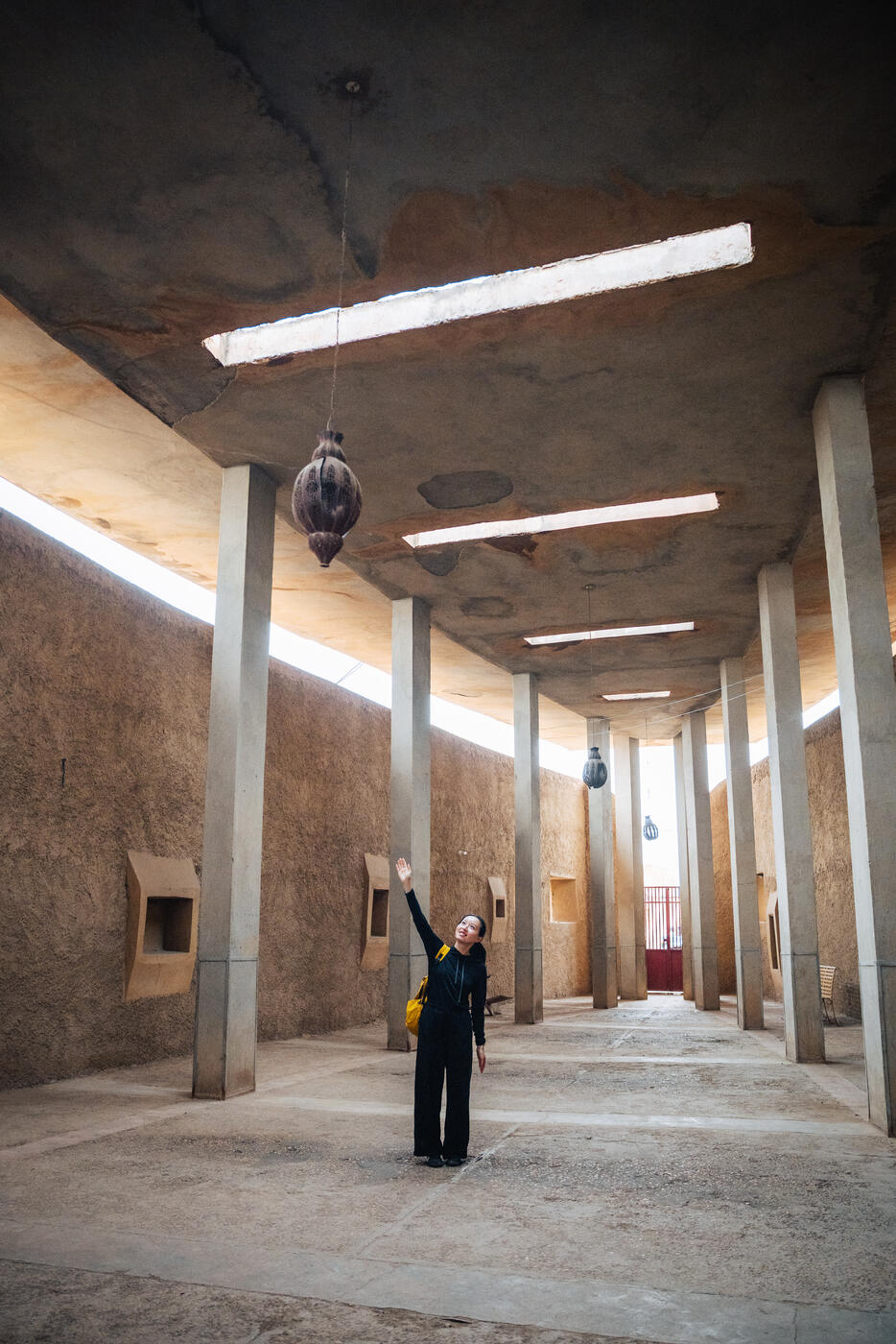 Person in large columned hall