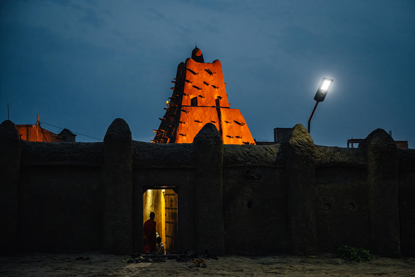Mosque illuminated at night with glowing minaret