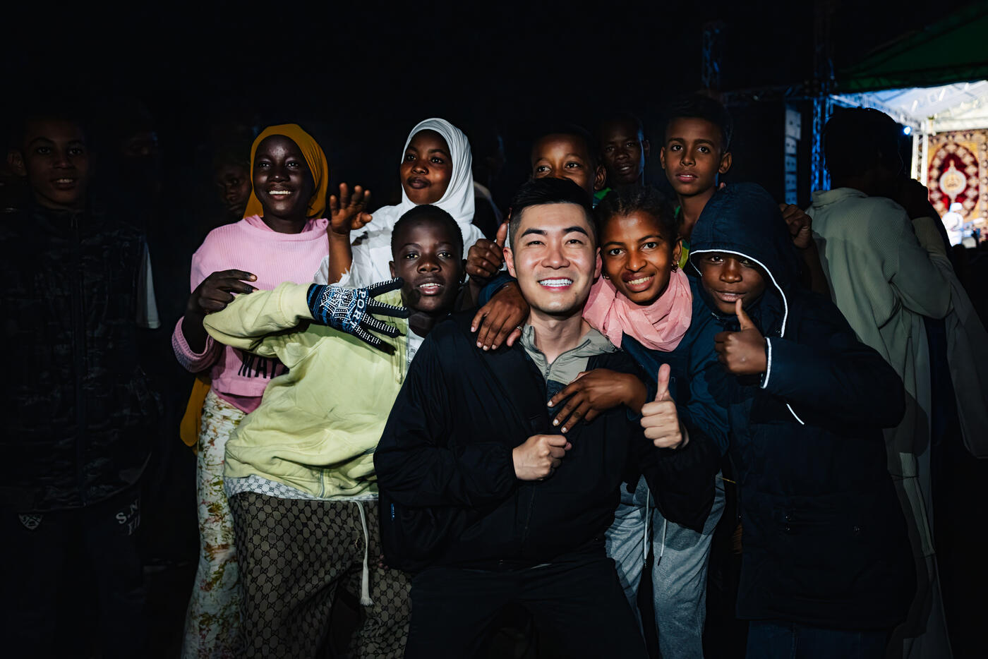 Nighttime group photo with local children