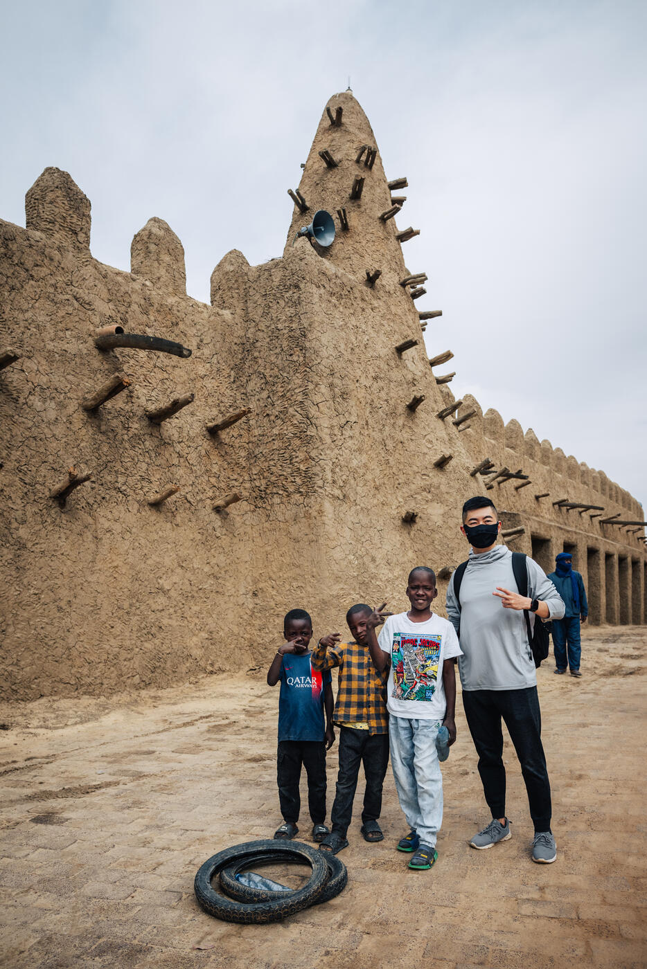 Person with children at mosque wall