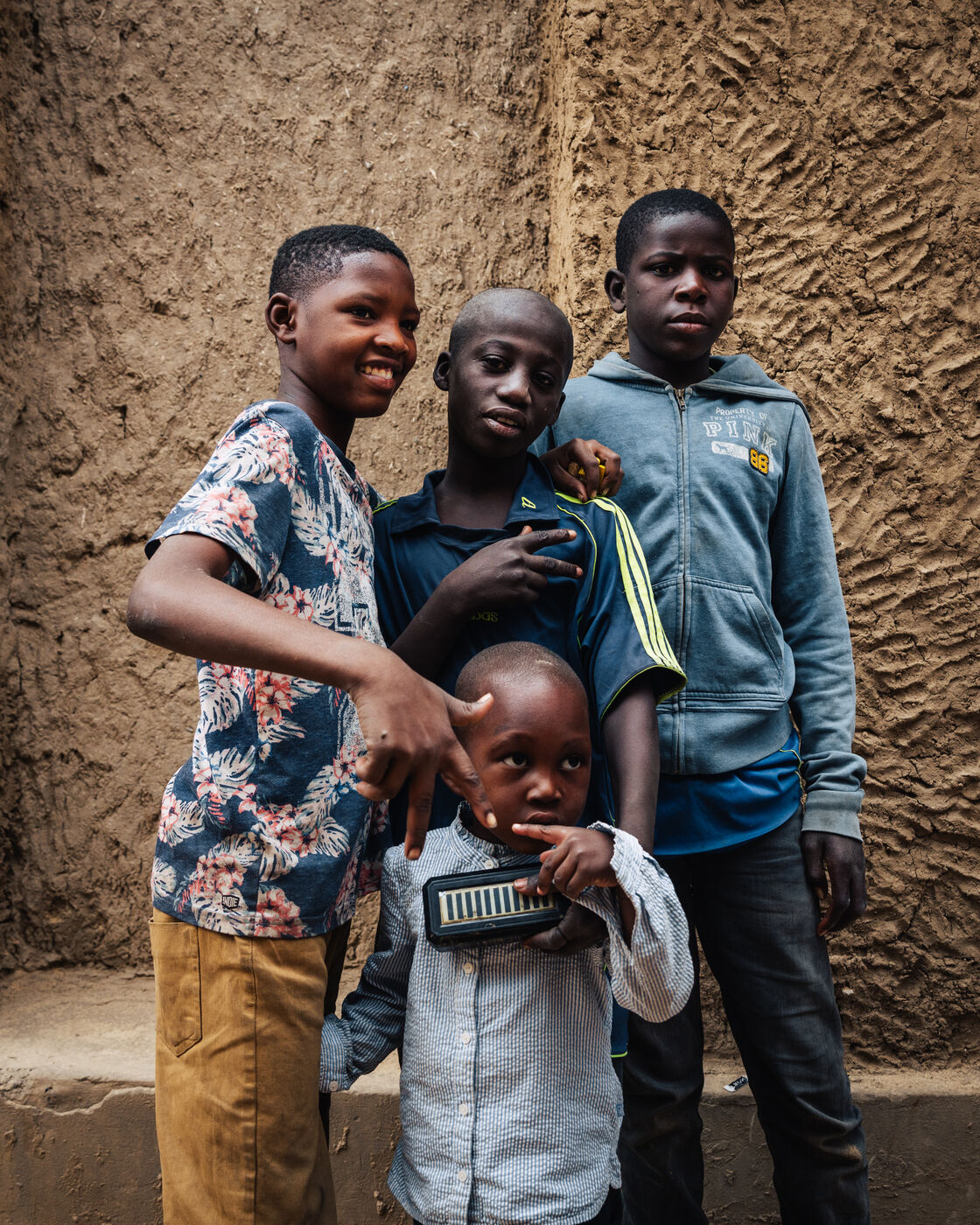 Four boys posing in narrow alley