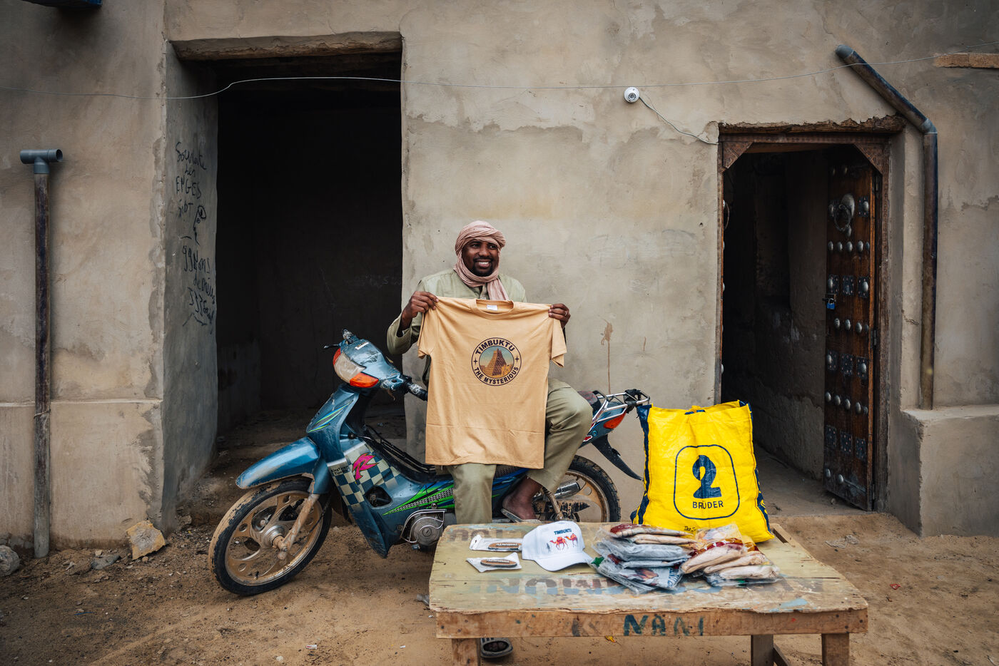 Man holding up t-shirt for sale