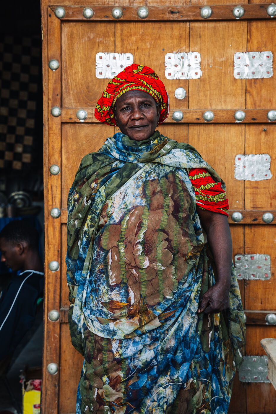 Woman in colorful clothing at doorway