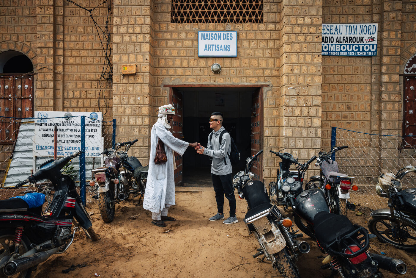 Handshake at entrance to Maison des Artisans