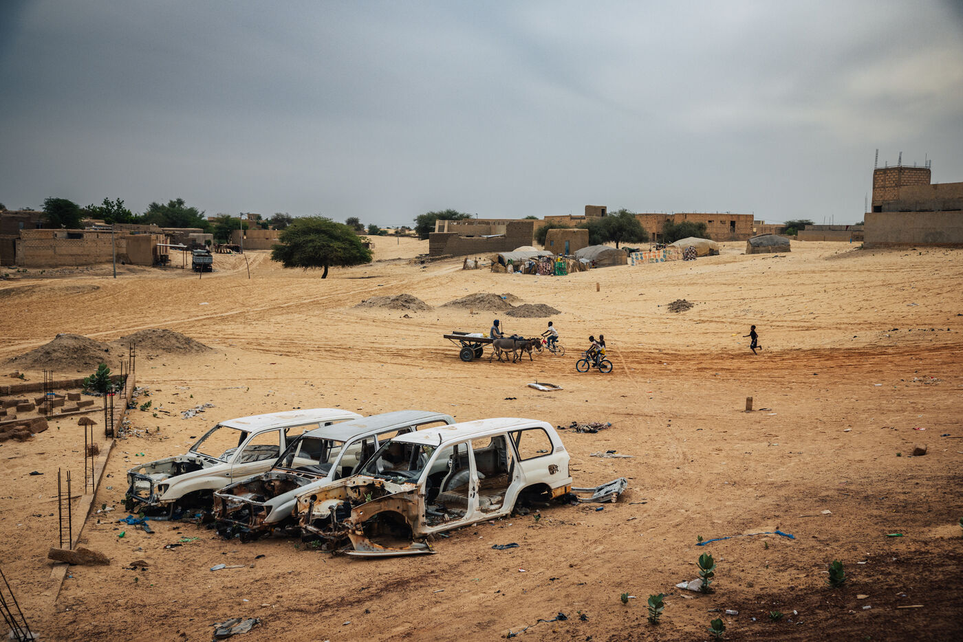 Destroyed vehicles in desert landscape