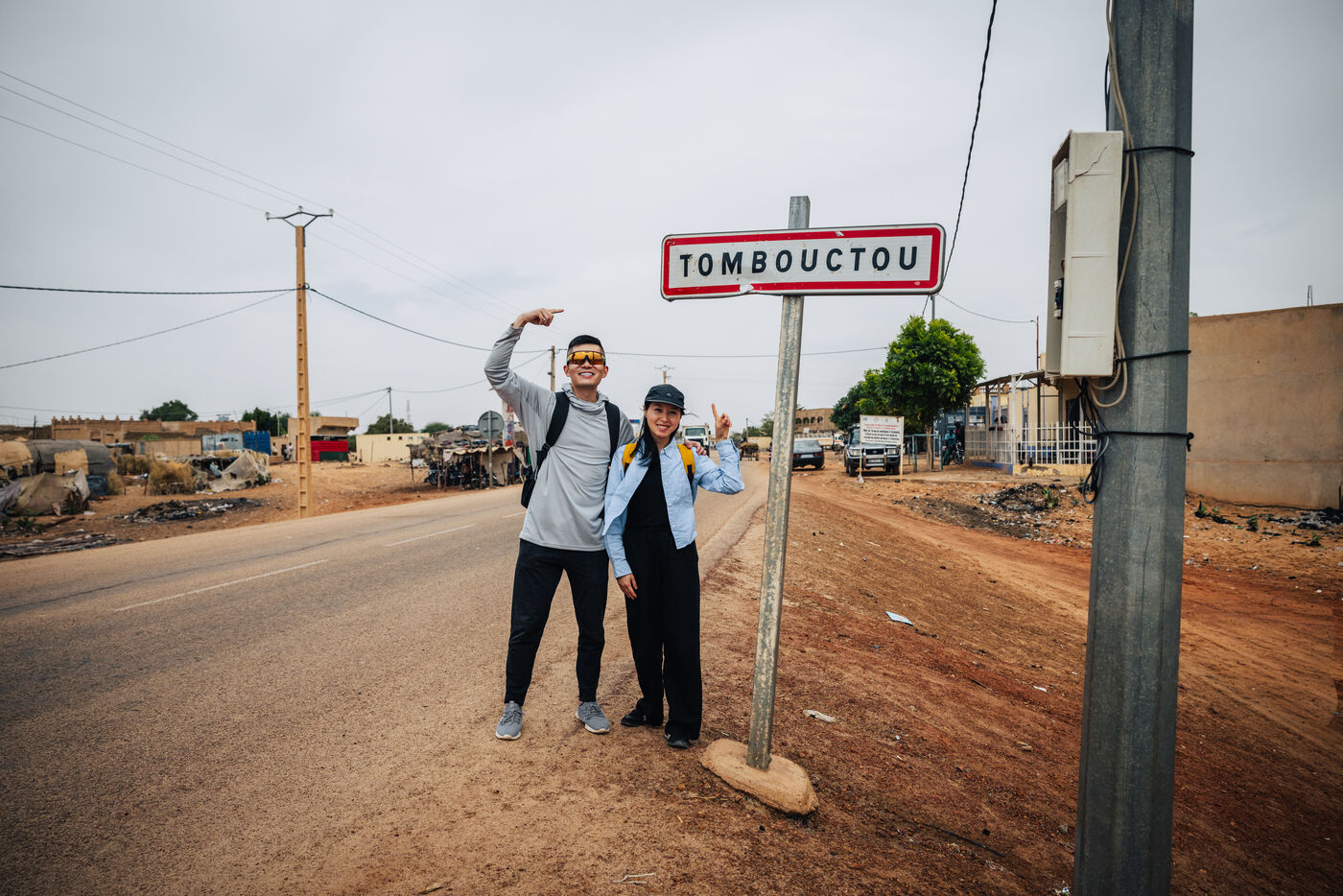 Two people at Tombouctou road sign