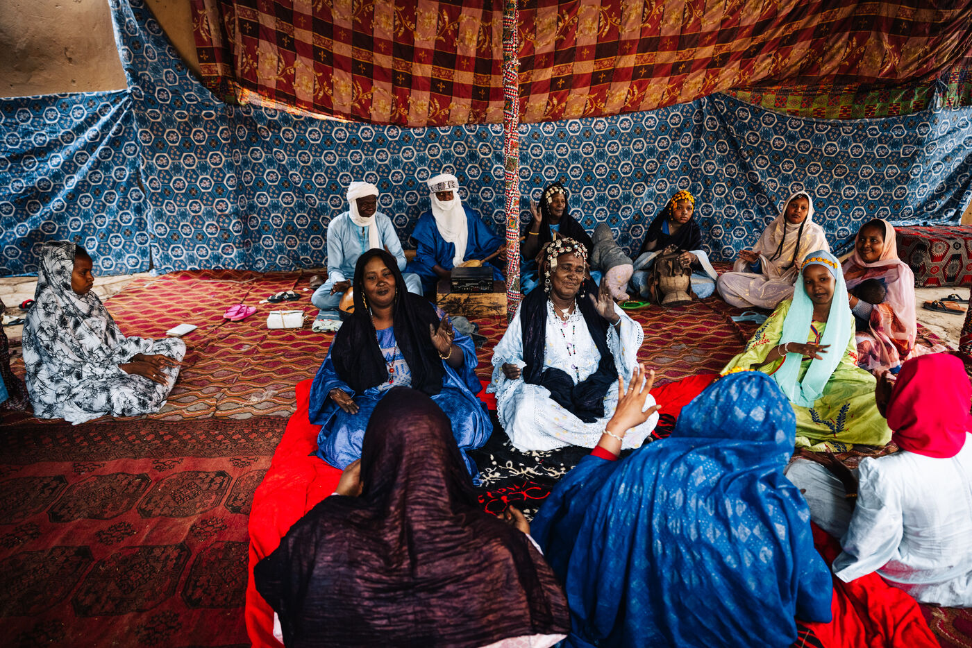 Group sitting in decorated Tuareg tent