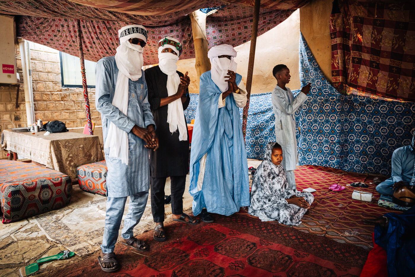 Tuareg men standing in blue tent