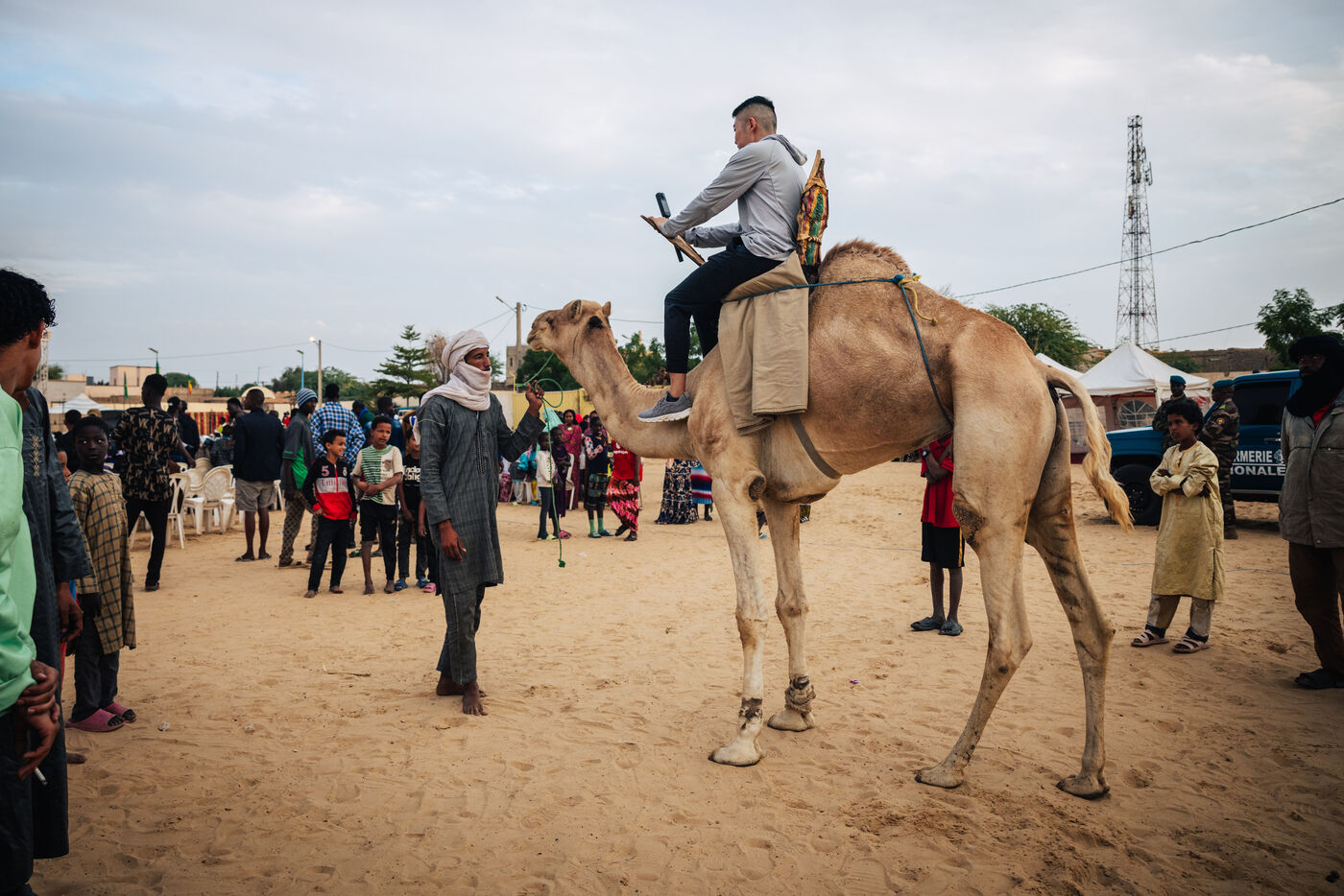 Person riding camel at festival grounds