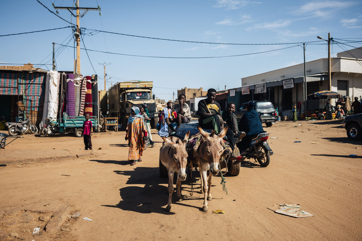 Donkeys and motorcycles on sandy market street
