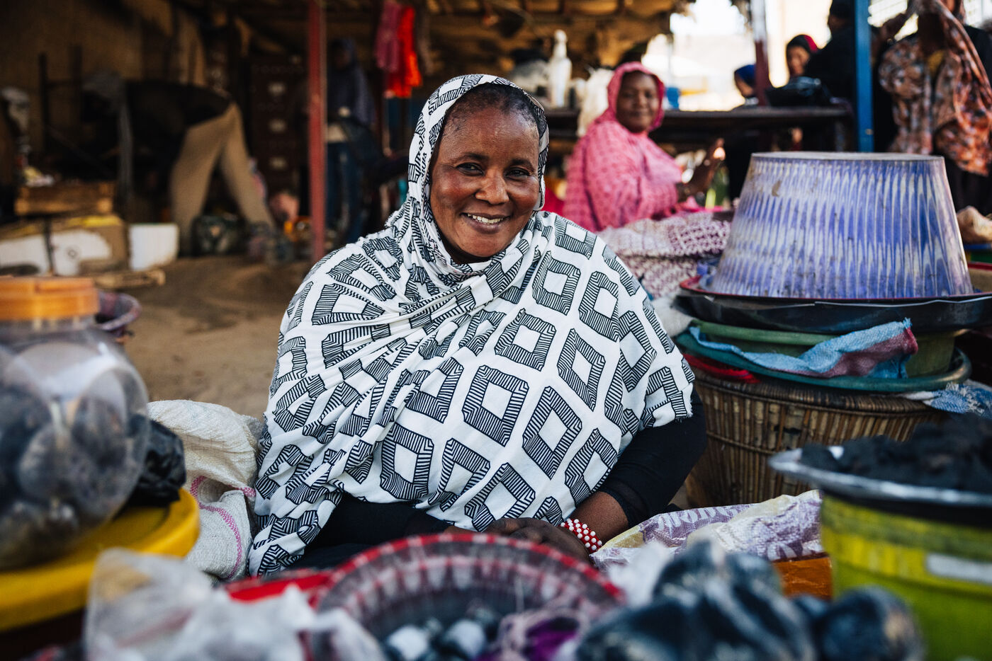 Smiling woman vendor at market stall