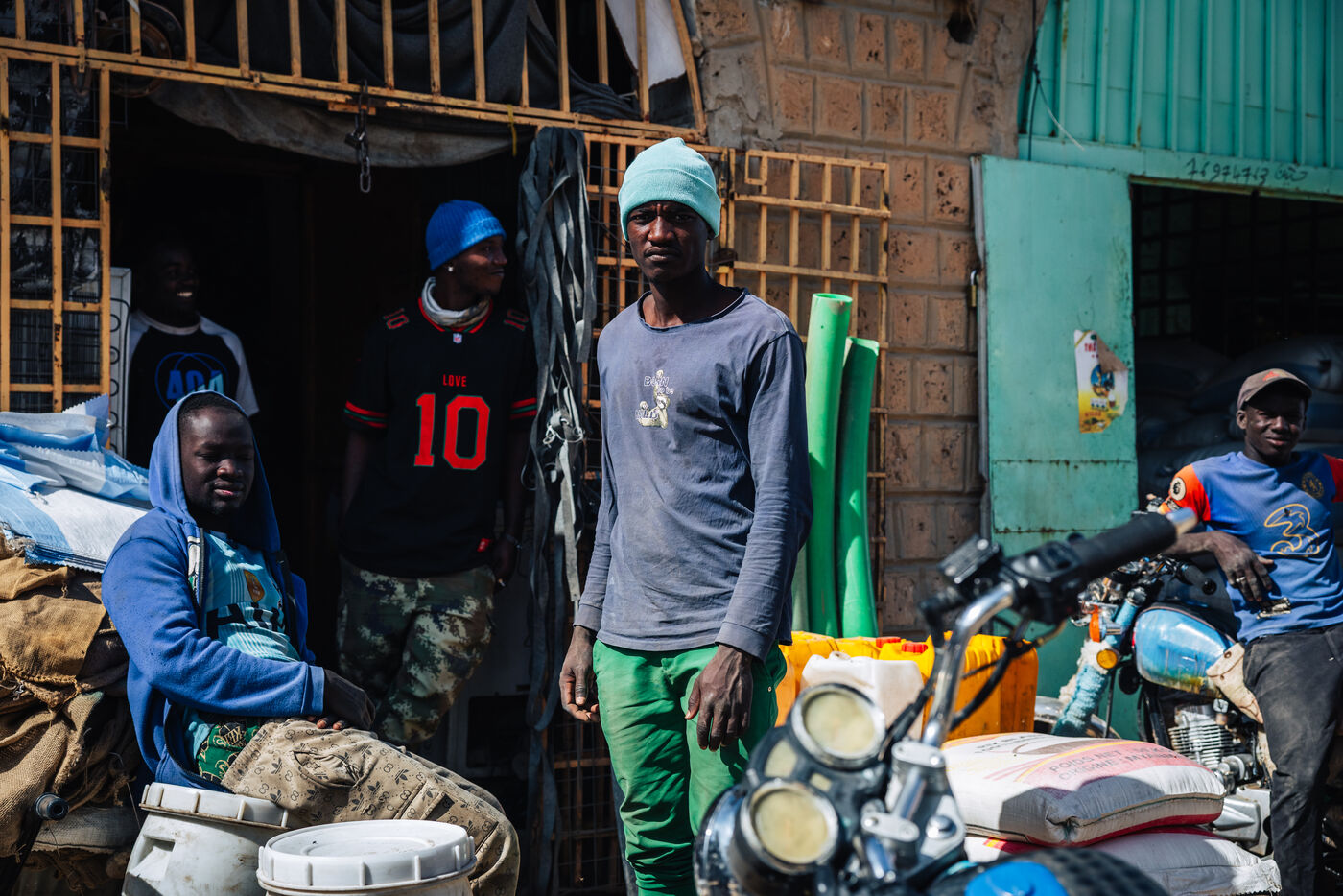 Men at market shop entrance