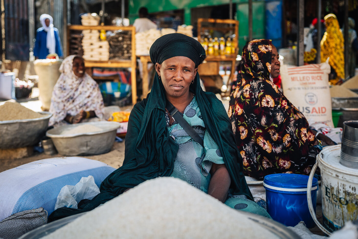 Woman at market with rice and grain