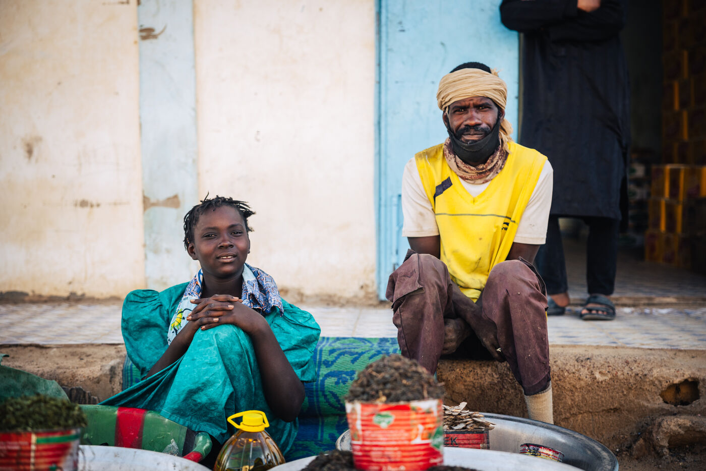 Two people sitting at market