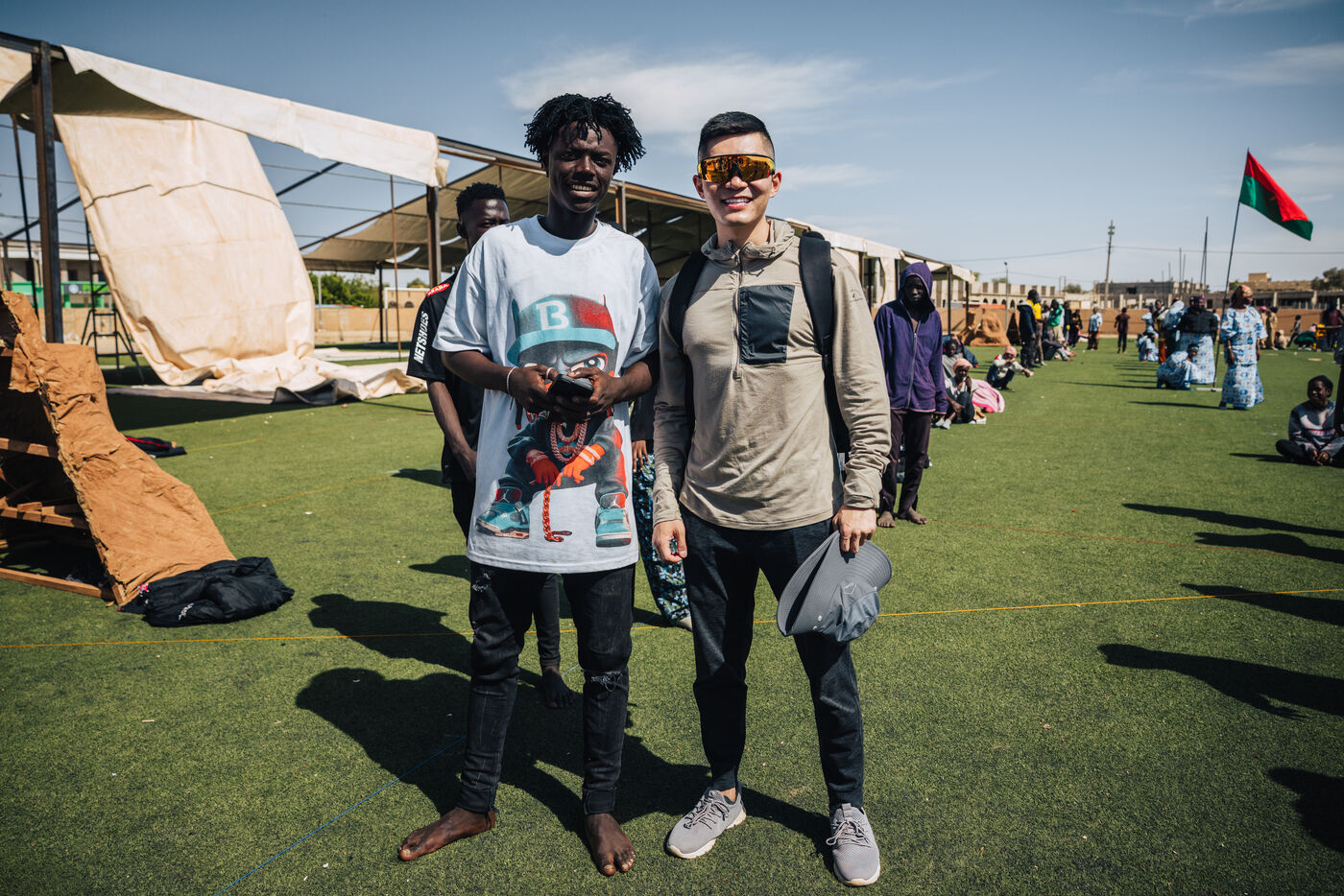 Two people at festival on green field
