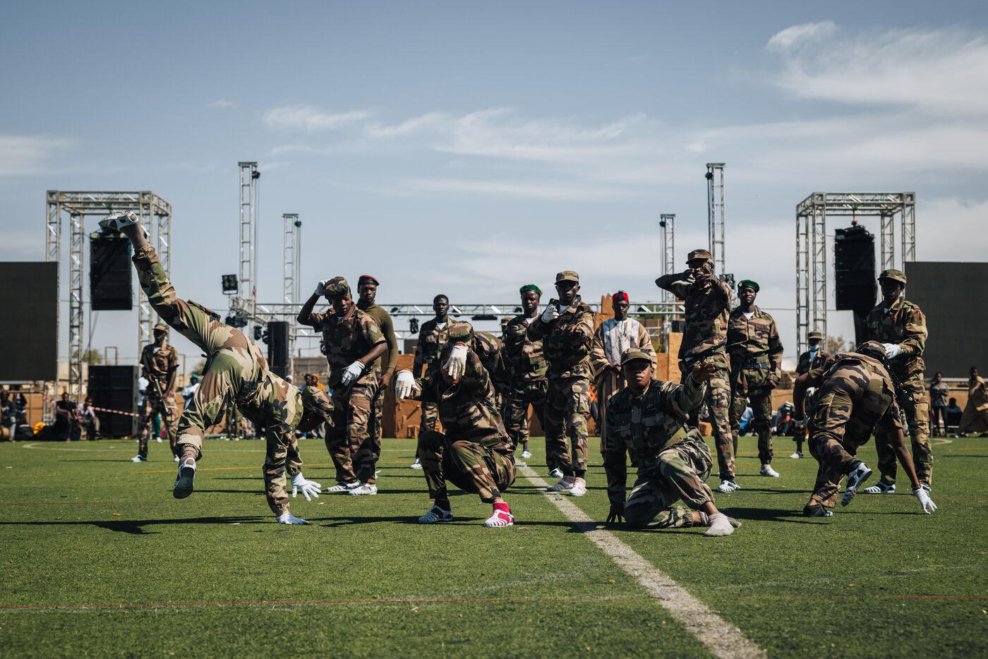 Dancers in camouflage performing on field