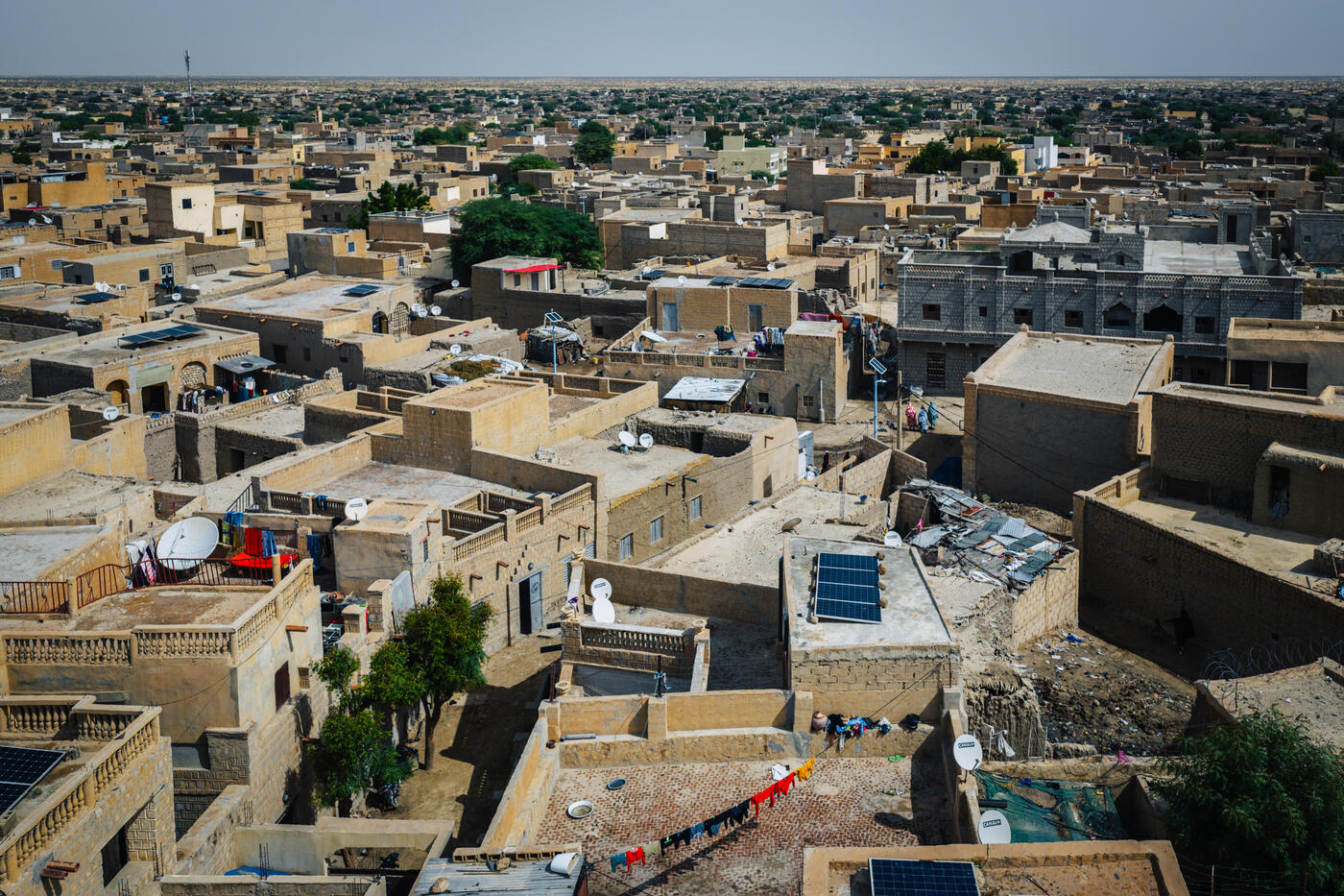 Aerial view over Timbuktu's flat rooftops, solar panels and satellite dishes in daylight