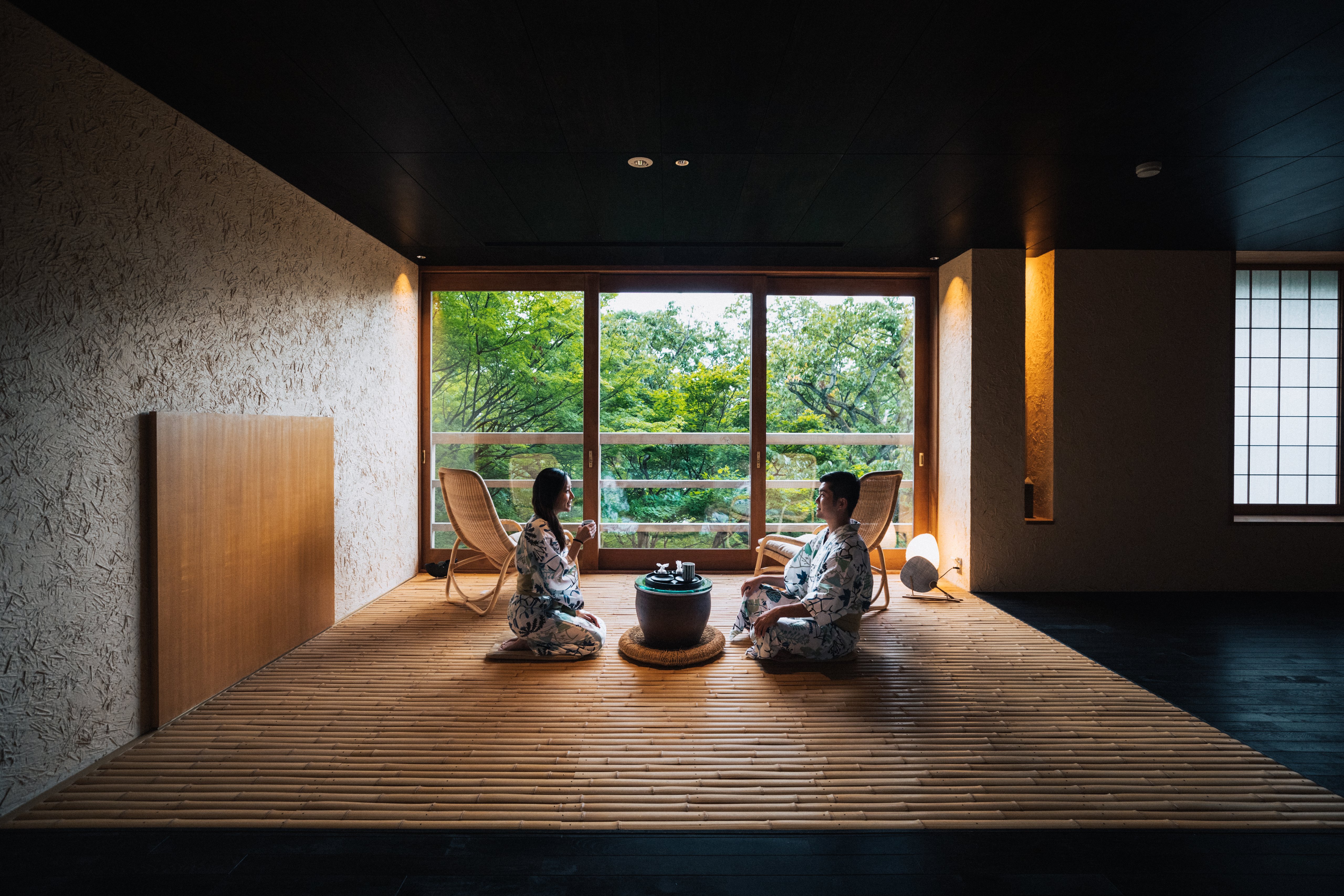 Two guests in yukata sitting in a traditional Japanese room at Beniya Mukayu ryokan