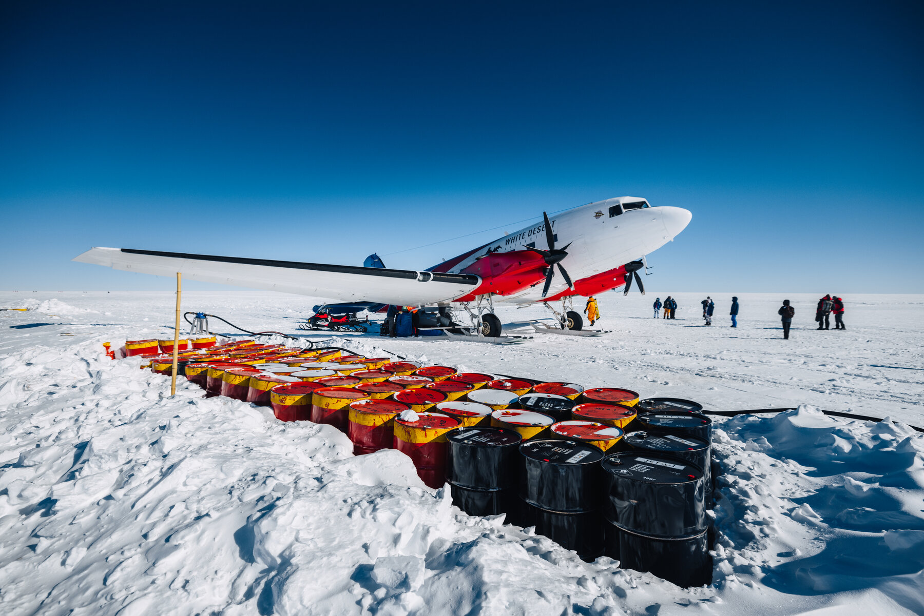 The Basler BT-67 being refueled from fuel drums at Dixie's Camp on the polar plateau