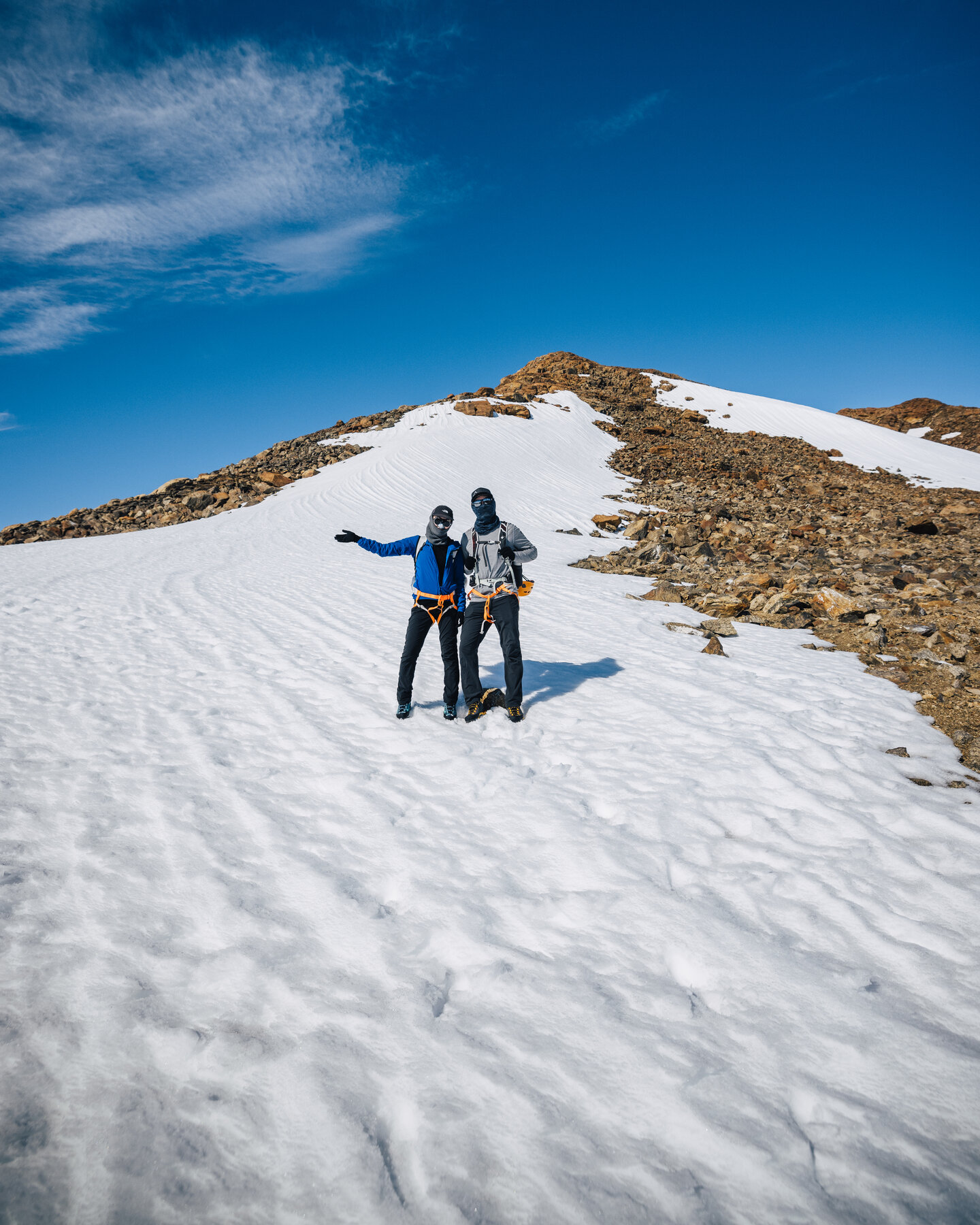 Jason and Grace portrait on a snowy ridge with the polar plateau stretching behind them