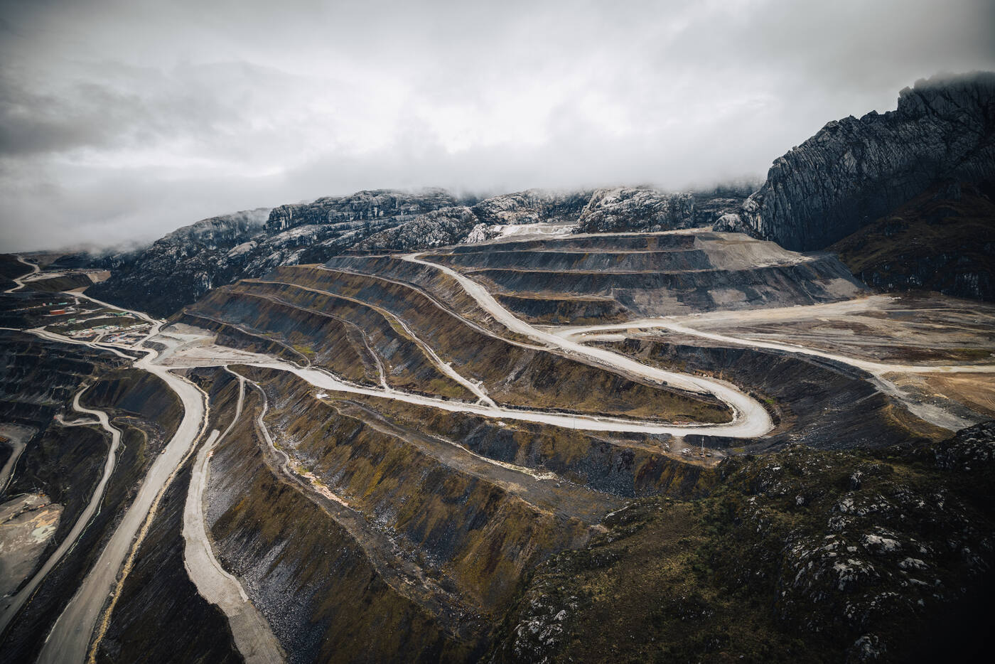 Aerial view of Grasberg open-pit mine with switchback roads and terraced excavation